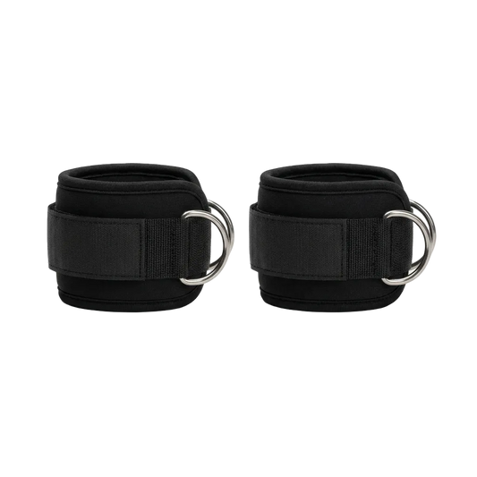 Pair of padded black ankle straps with D-rings for cable machines, studio product photo